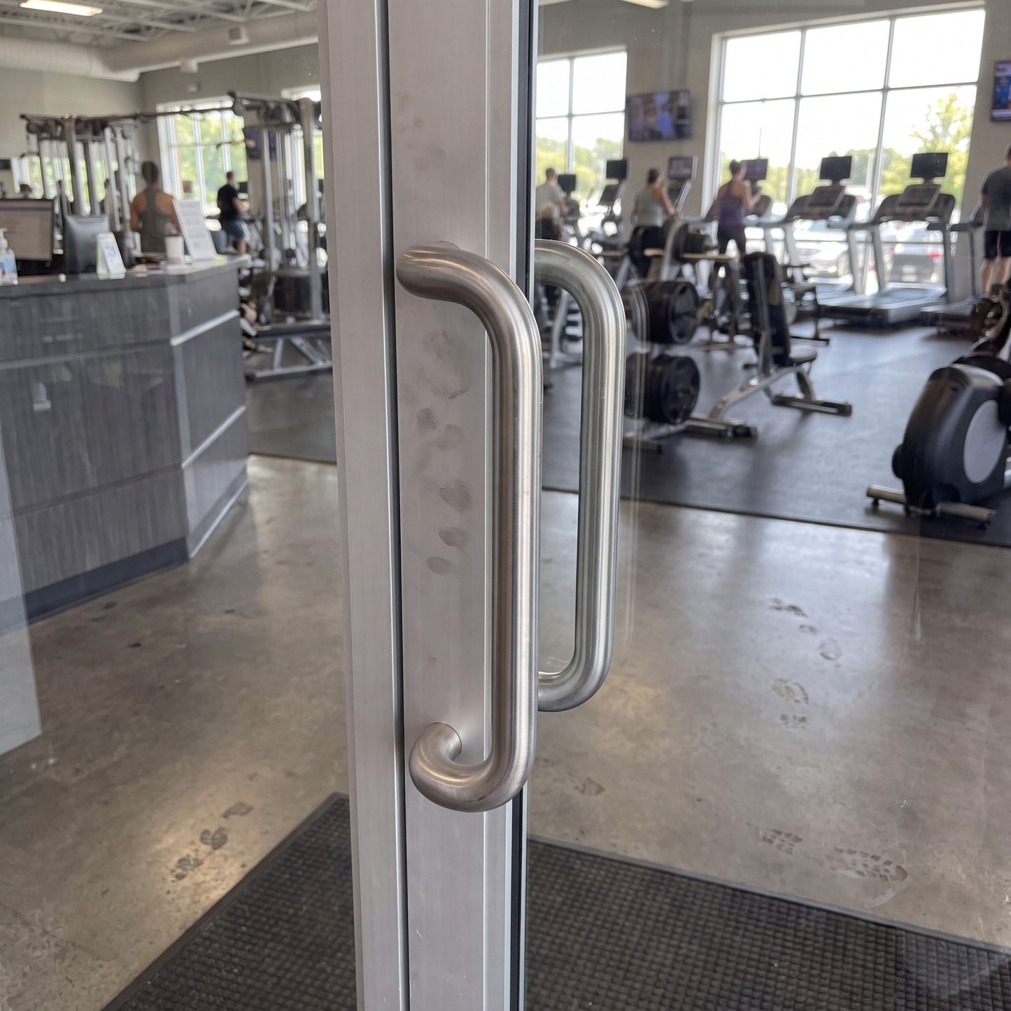 Round Offset pull handle in 316 stainless on an entrance door