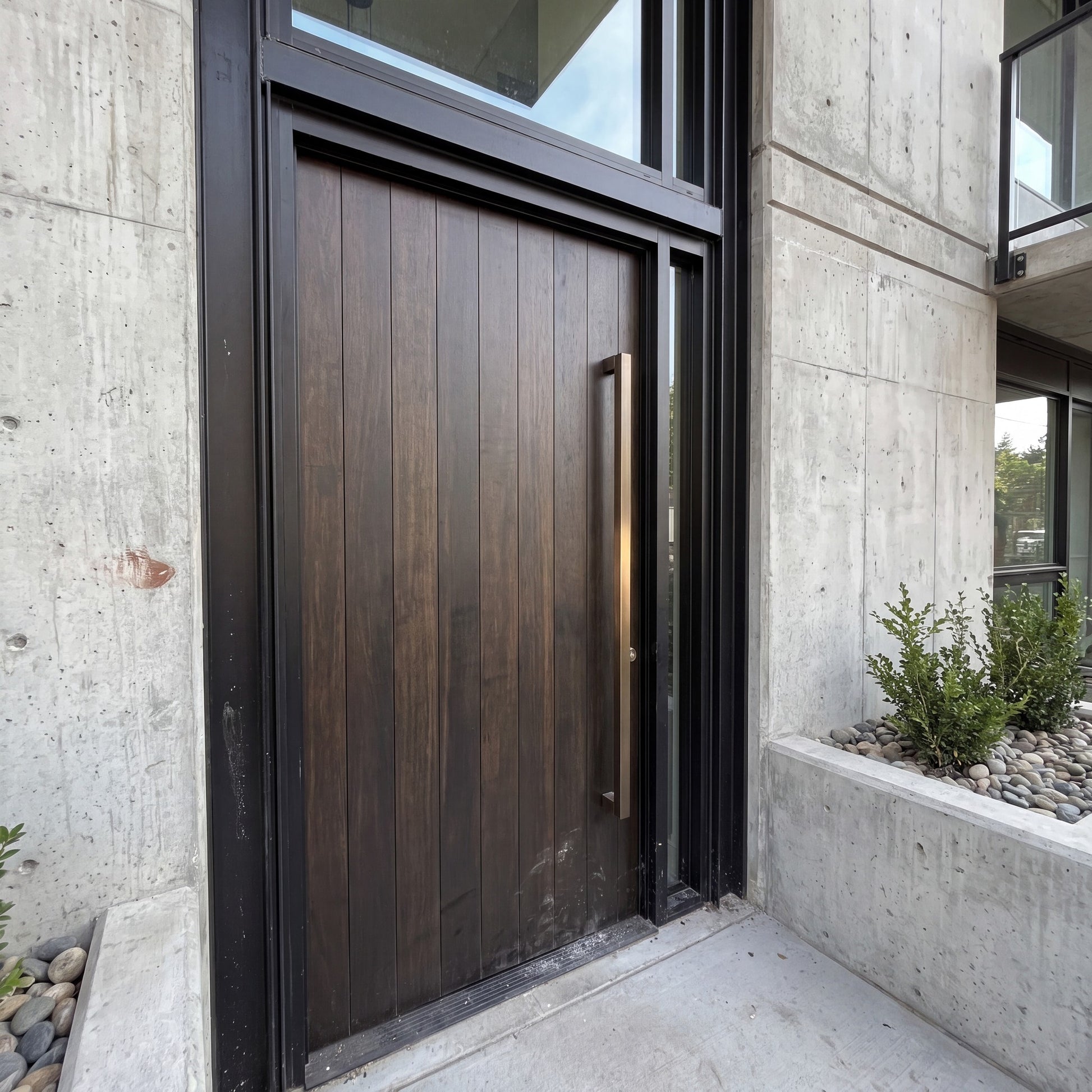 Bluff Bar pull handles in bronze on a timber entrance door