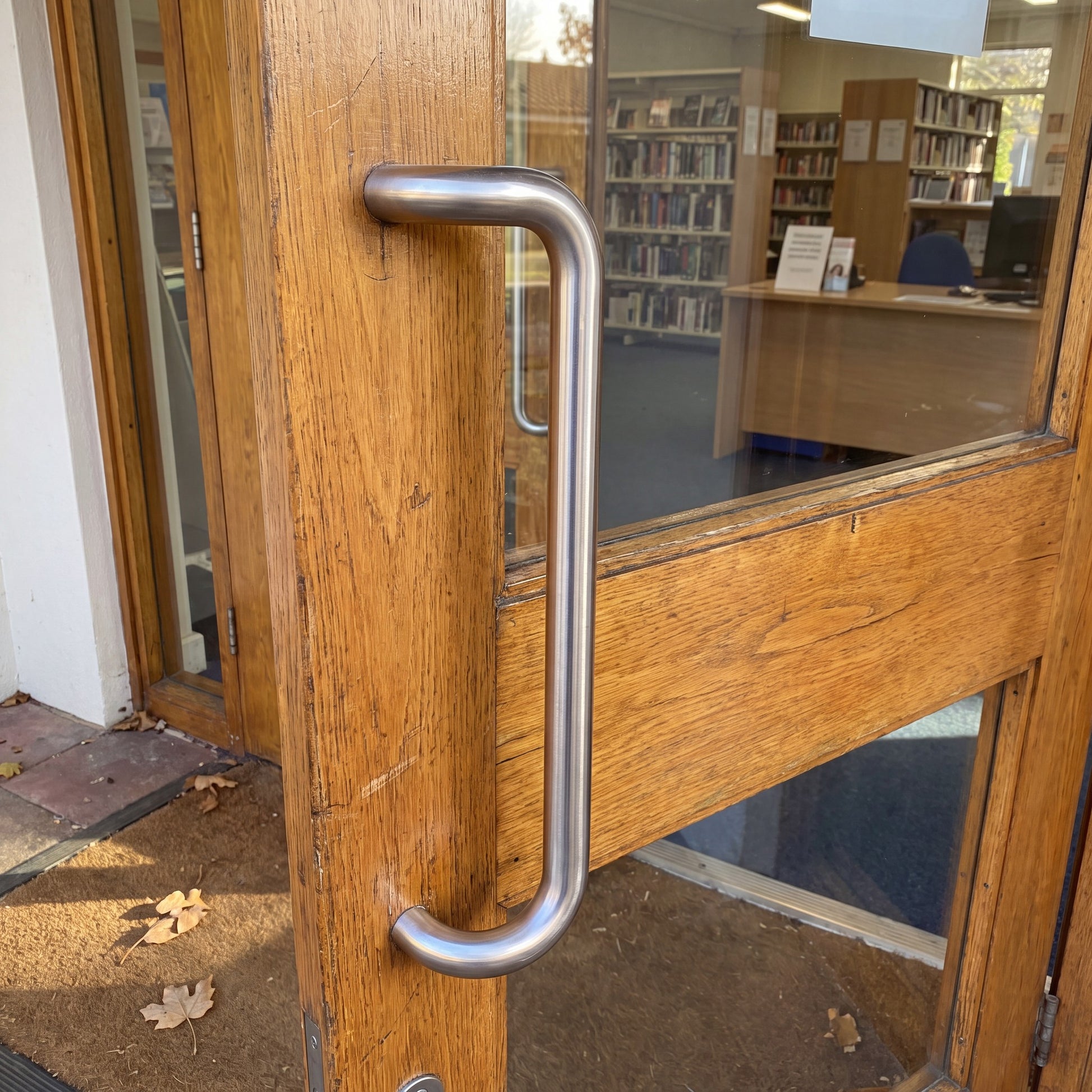 Round Offset pull handle in 316 stainless on a timber door