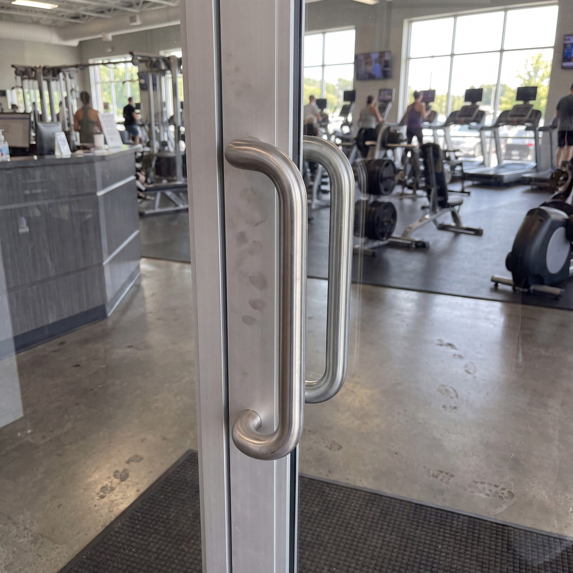 Round Offset pull handle in 316 stainless on an entrance door