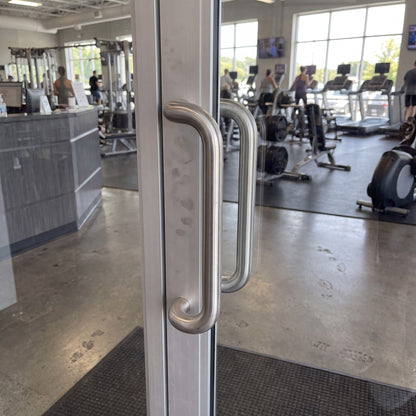 Round Offset pull handle in 316 stainless on an entrance door